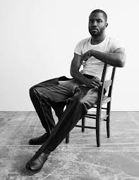 black and white of frank ocean sitting in a chair