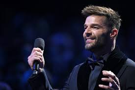 ricky martin on stage with microphone in hand